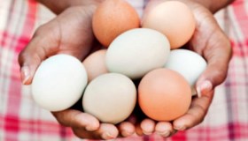 Black woman holding eggs
