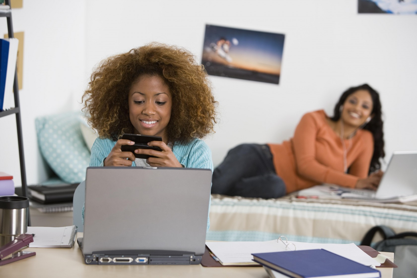 Women using laptops and cell phone