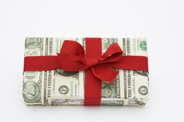 A gift wrapped in dollar bills