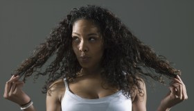 Woman holding hair, looking away