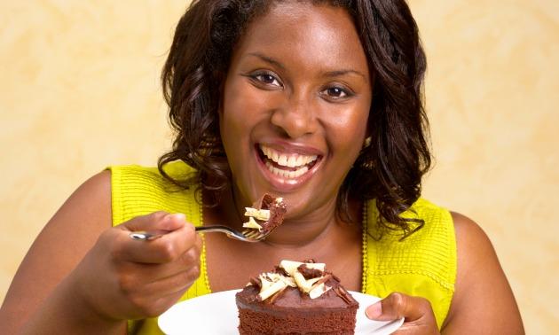 Black woman eating cake