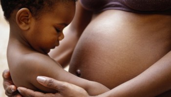 black pregnant woman with baby