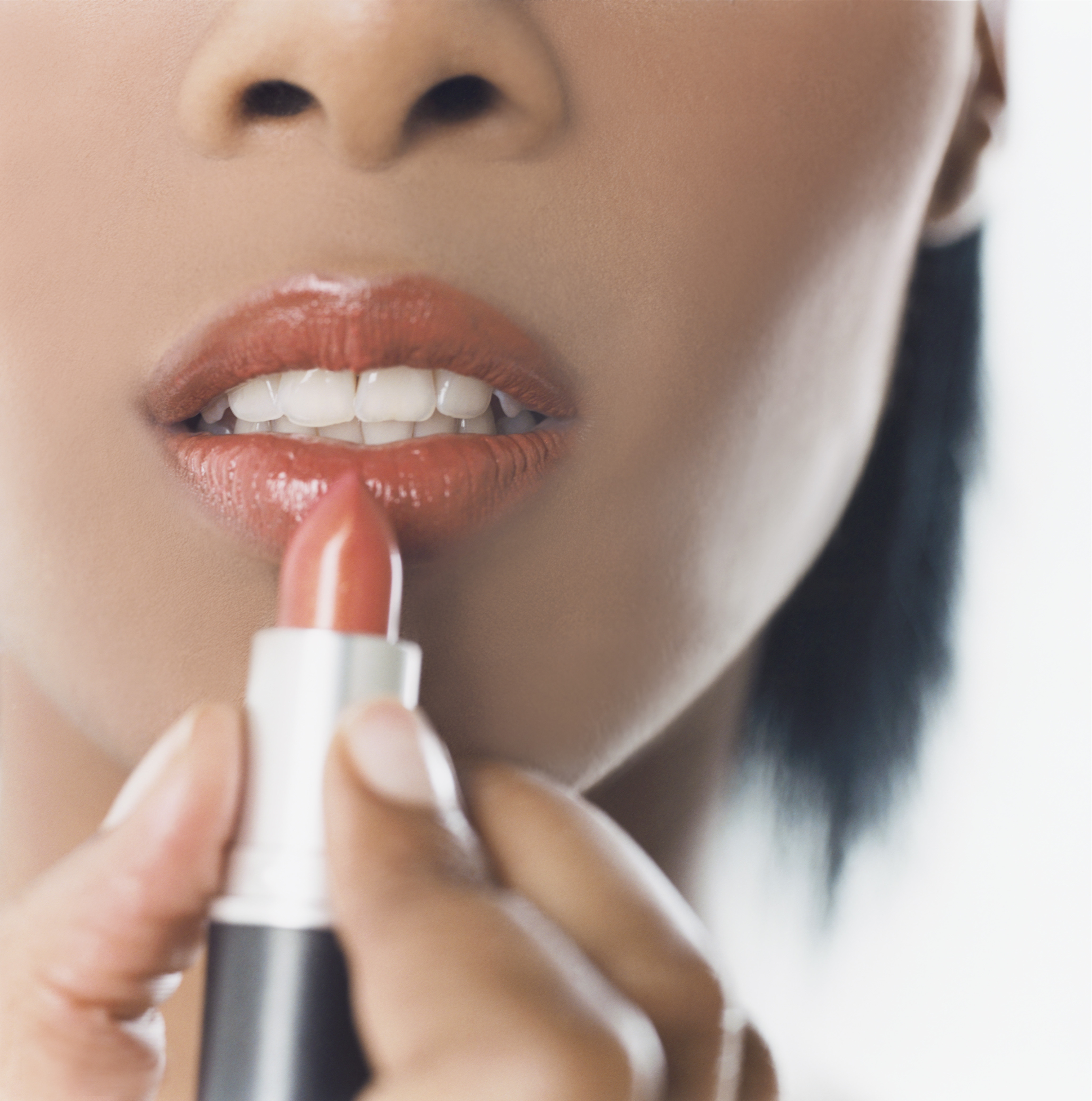 Woman Putting on Lipstick