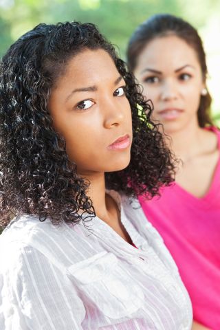 Serious young woman angry with friend