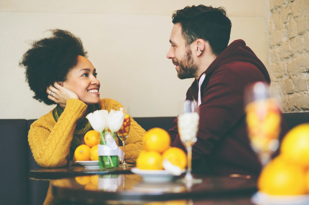 Mixed race couple at coffee shop talking