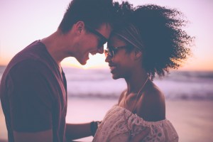 Mixed race couple sharing a romantic moment at sunset