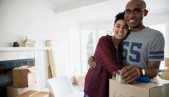 Portrait of smiling couple with moving boxes