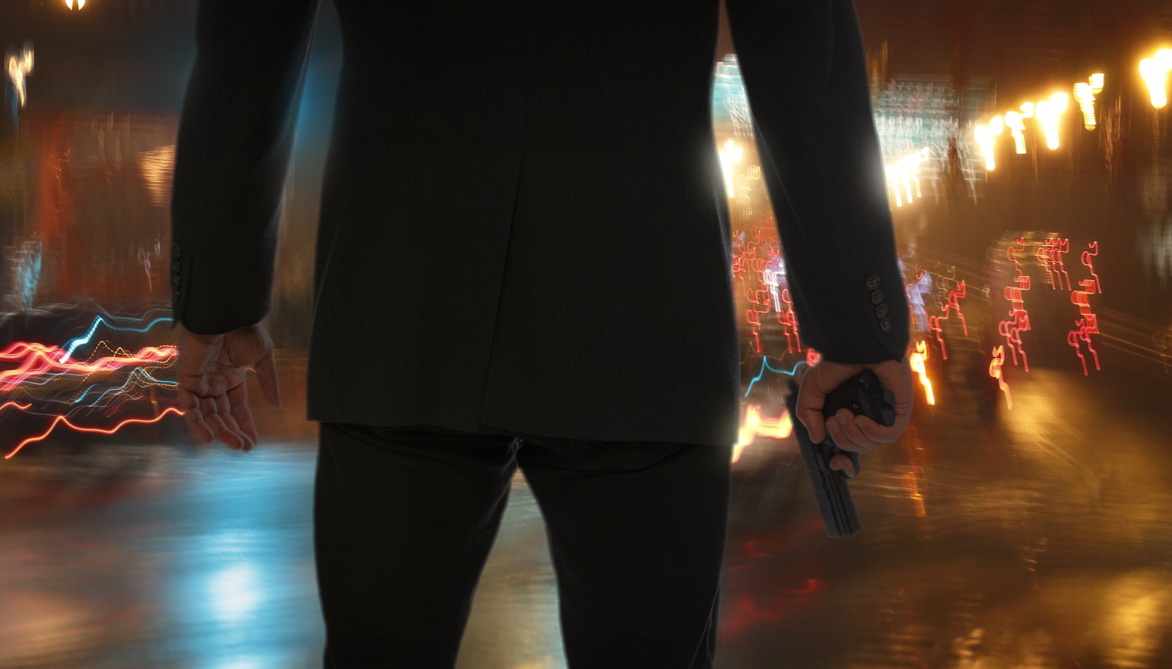 Bodyguard standing with gun during rain at night.