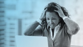 Black woman upset looking at computer