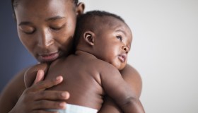 Close up of Black mother holding baby