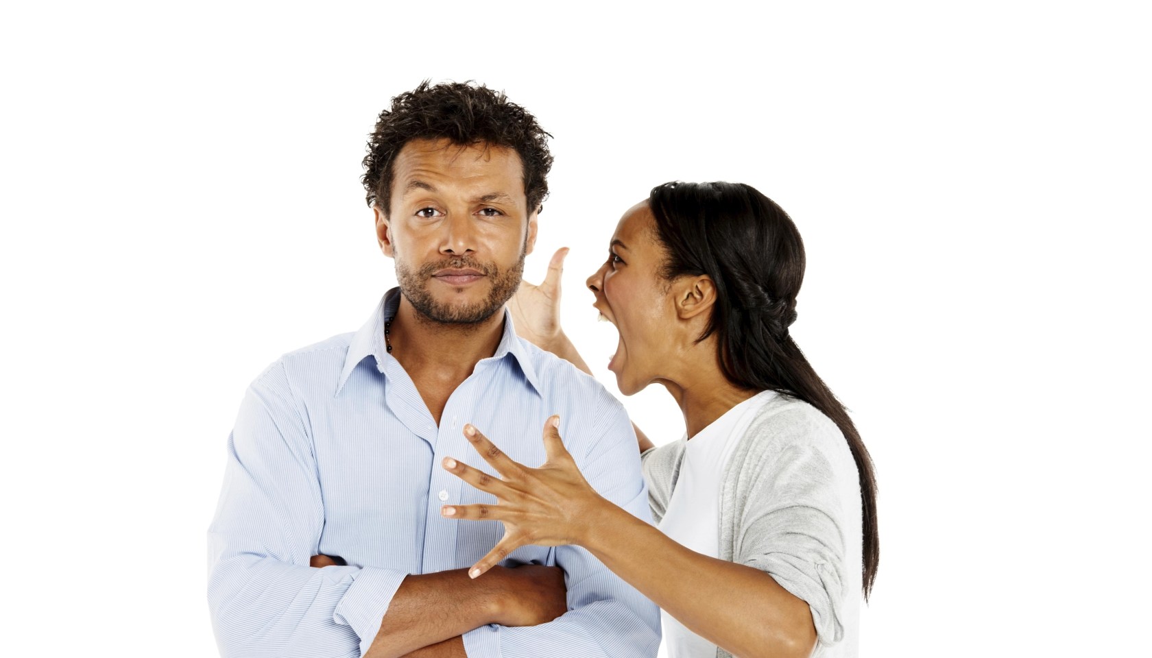 Portrait of young woman shouting at her boyfriend against white background