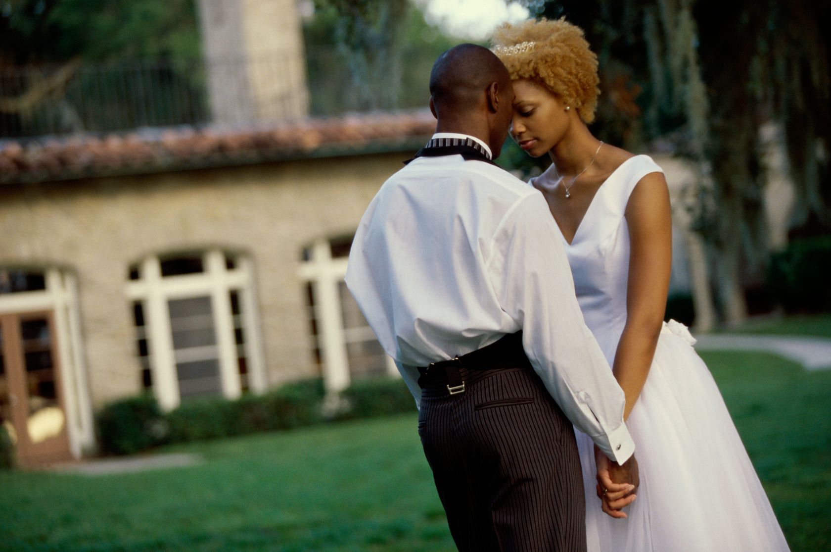 Newlywed couple holding hands