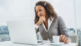 Pensive African American businesswoman using computer at office.