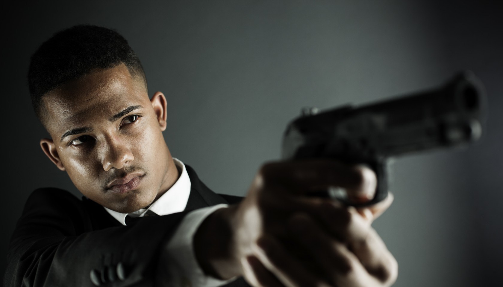 Security agent or criminal holding a hand gun.