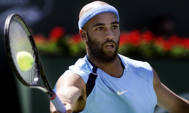 James Blake gets the ball right on the racket during a forehand shot against Roger Federer in the f