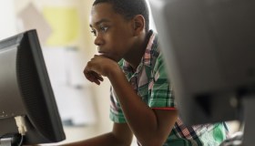 Black students using computers in classroom