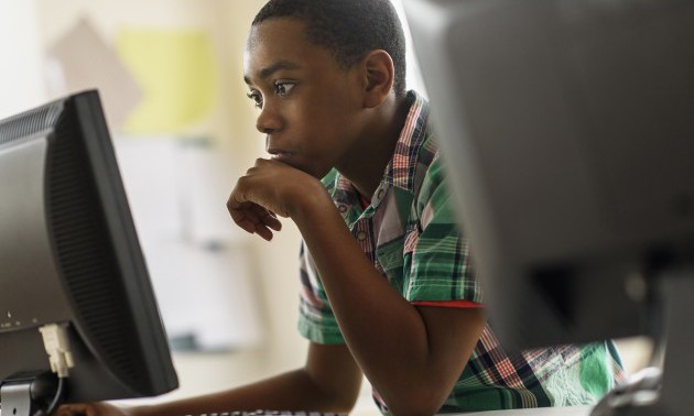 Black students using computers in classroom