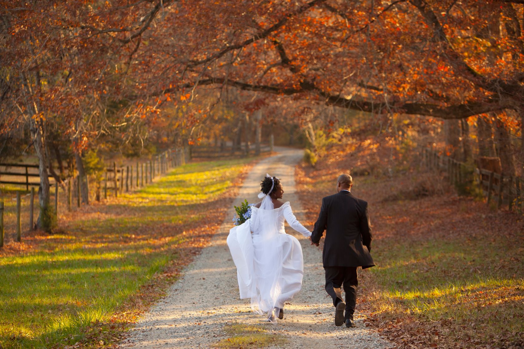 African American bride and groom walking on path
