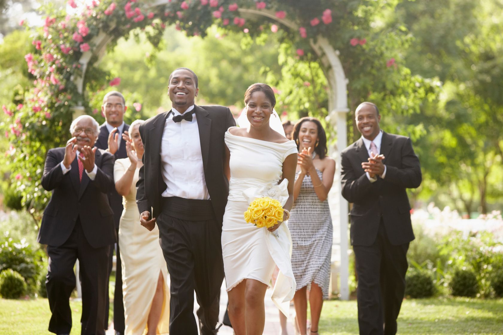 Wedding guests applauding newlyweds