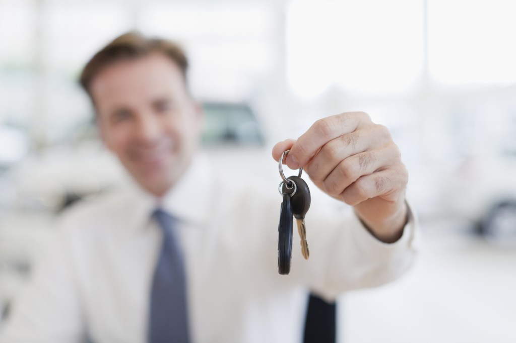 Close up of car salesman holding keys