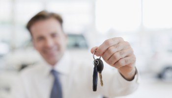 Close up of car salesman holding keys