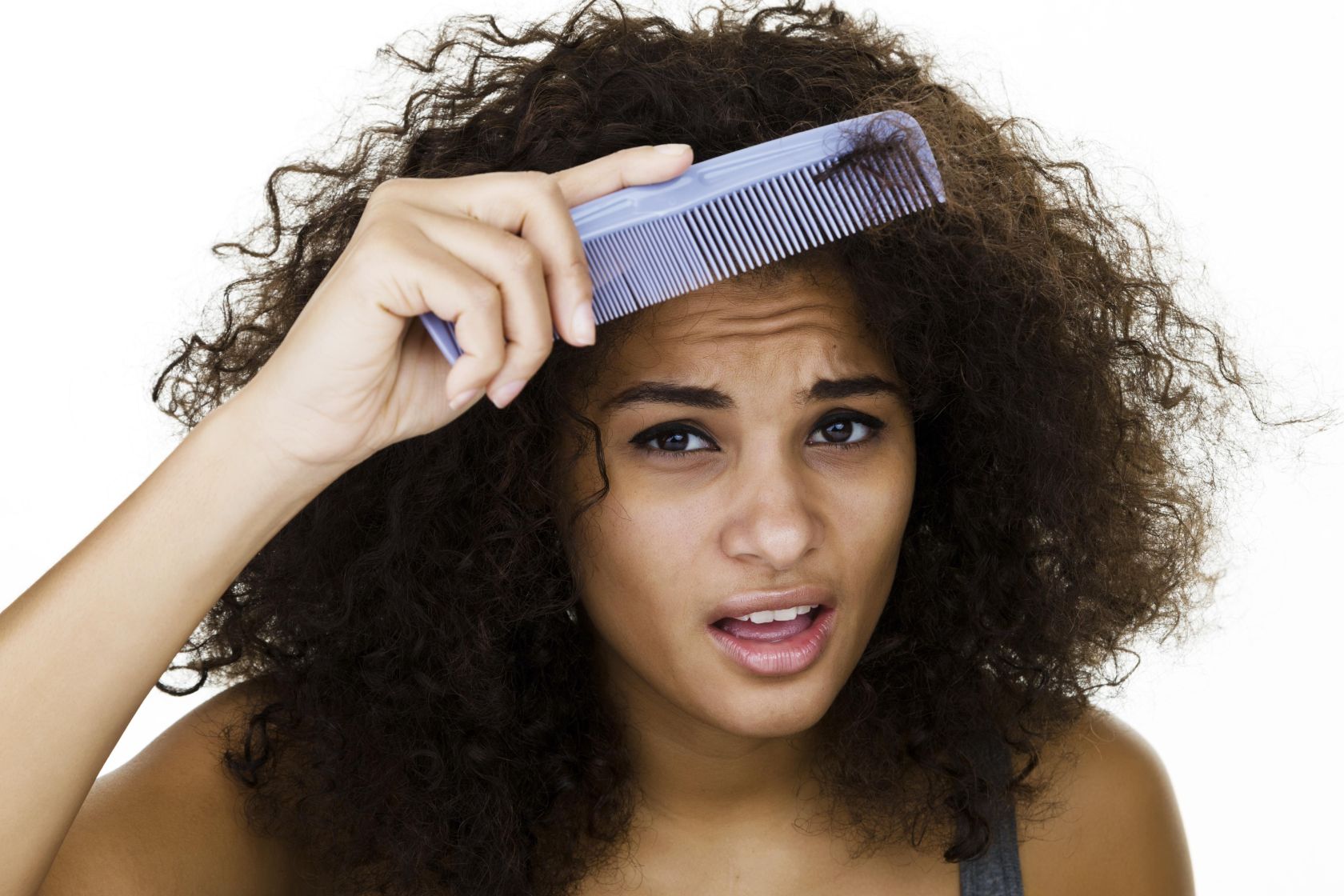 Woman trying to comb her frizzy hair