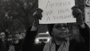 Black Woman Holding Protest Sign