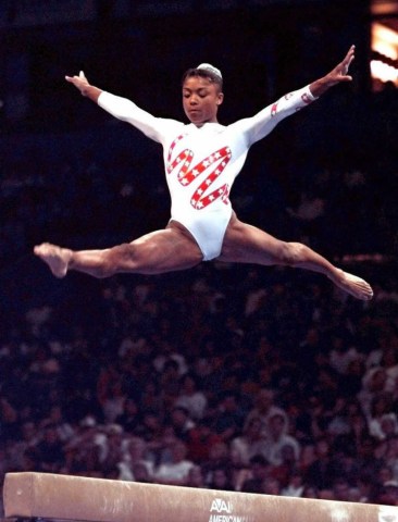 Dominique Dawes performs on the balance beam durin