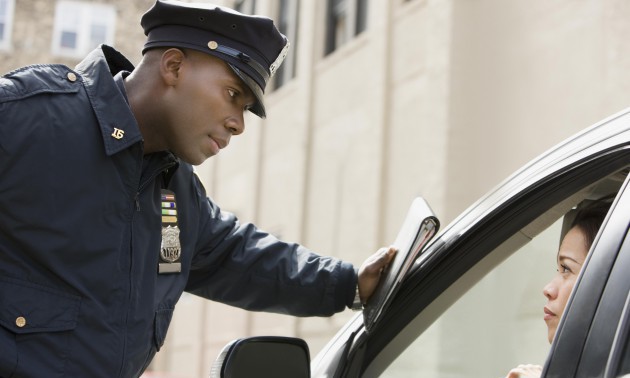 African policeman giving woman ticket