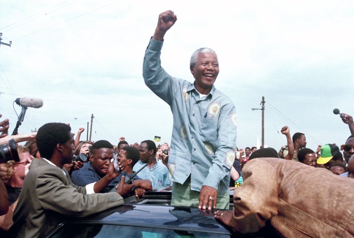 Mandela celebrates before his historic win in 1994.
