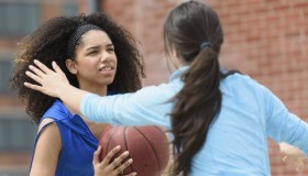 USA, New Jersey, Teenage girls (14-15, 16-17) playing basketball