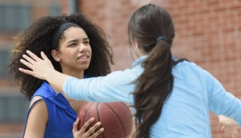 USA, New Jersey, Teenage girls (14-15, 16-17) playing basketball