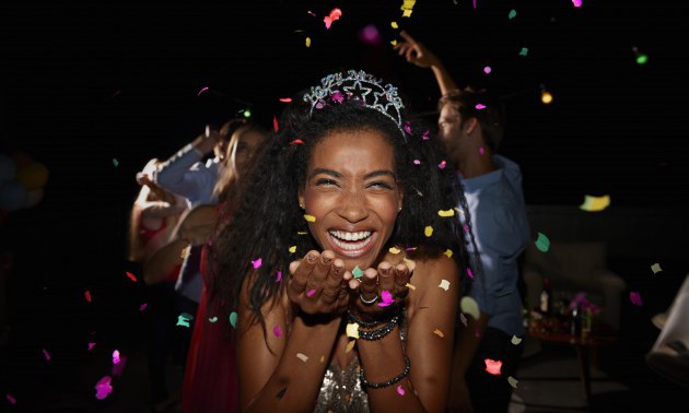 Young woman blowing confetti