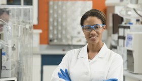 Black scientist smiling in laboratory