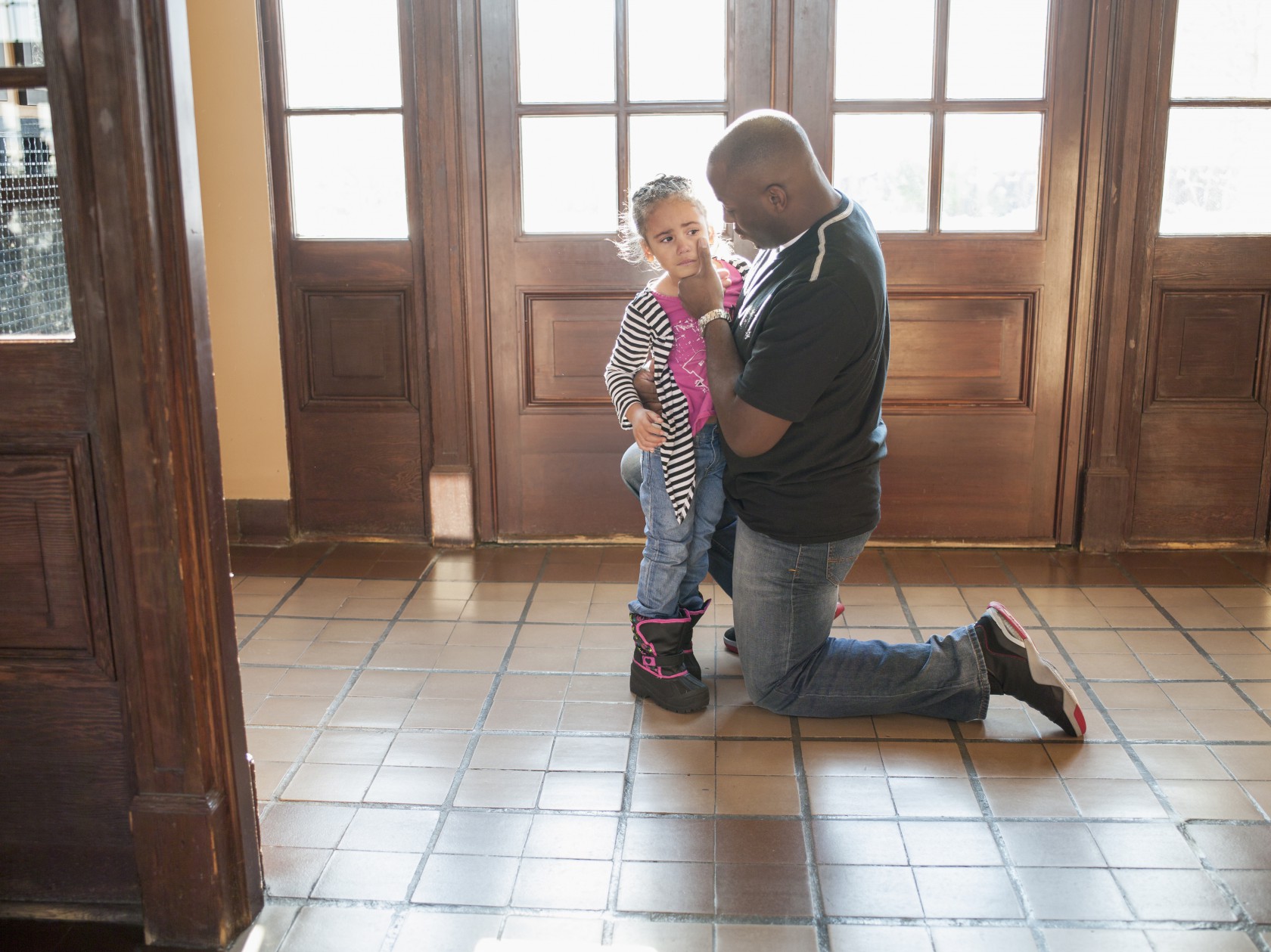 Father comforting his crying daughter