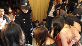 A Chinese police officer interrogates a