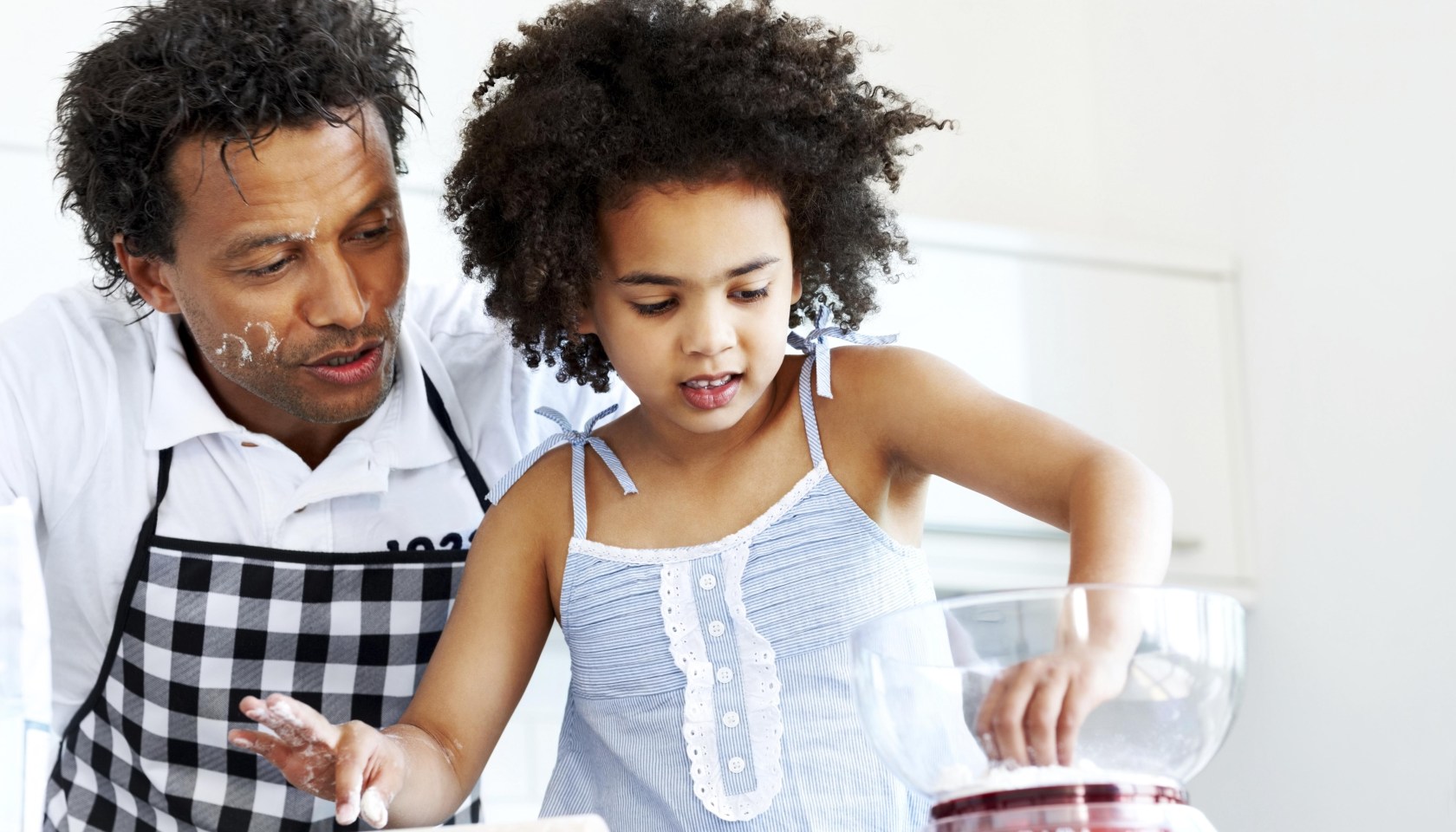 Father and daughter together baking
