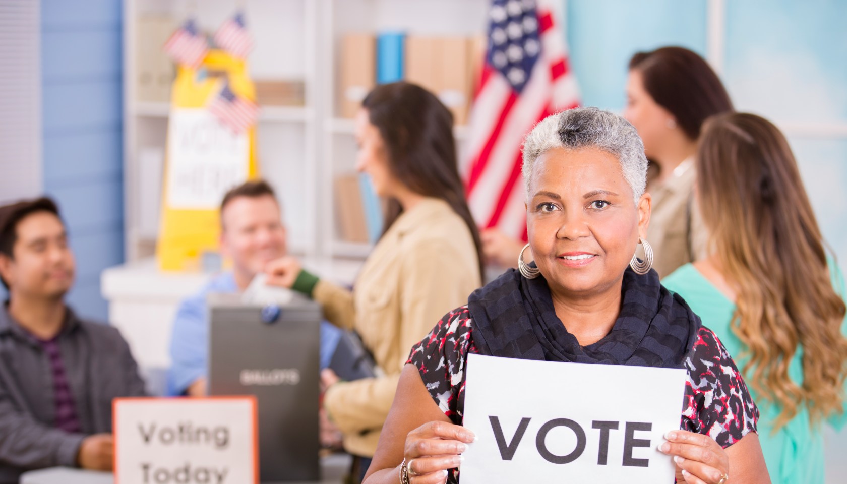 Voters register, voting in USA elections. Woman holds 'Vote' sign.
