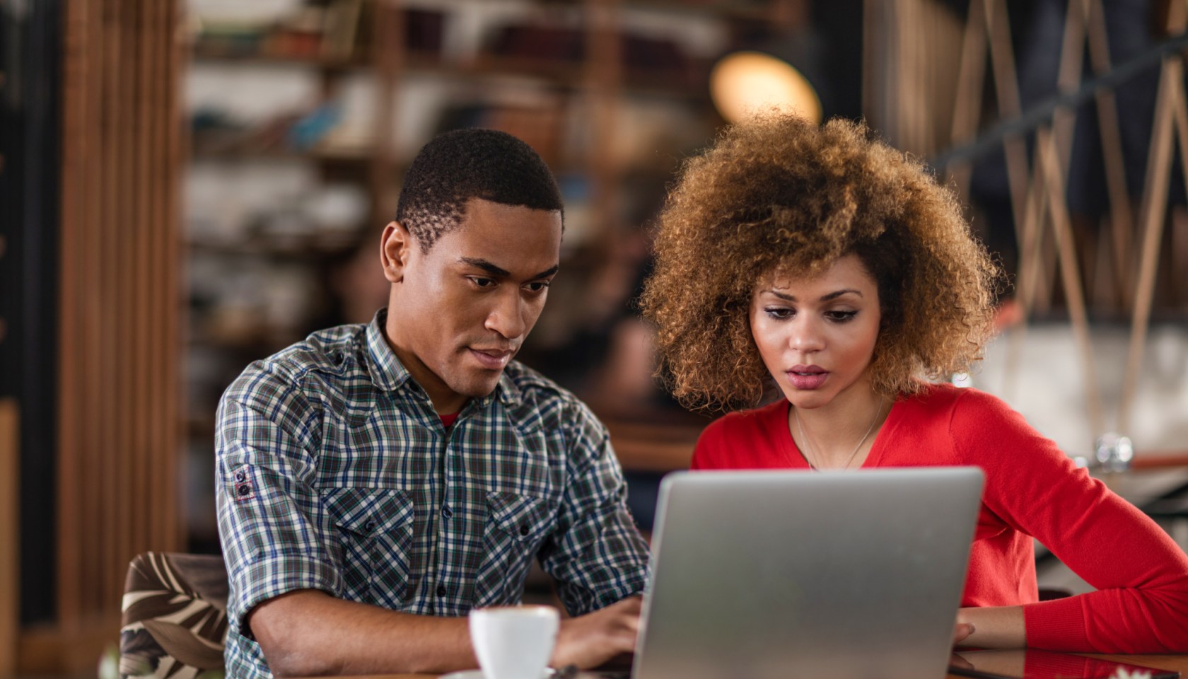 African American business colleagues working together on a laptop.
