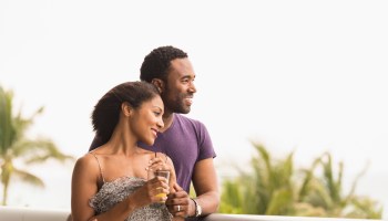 Couple admiring scenic view from balcony