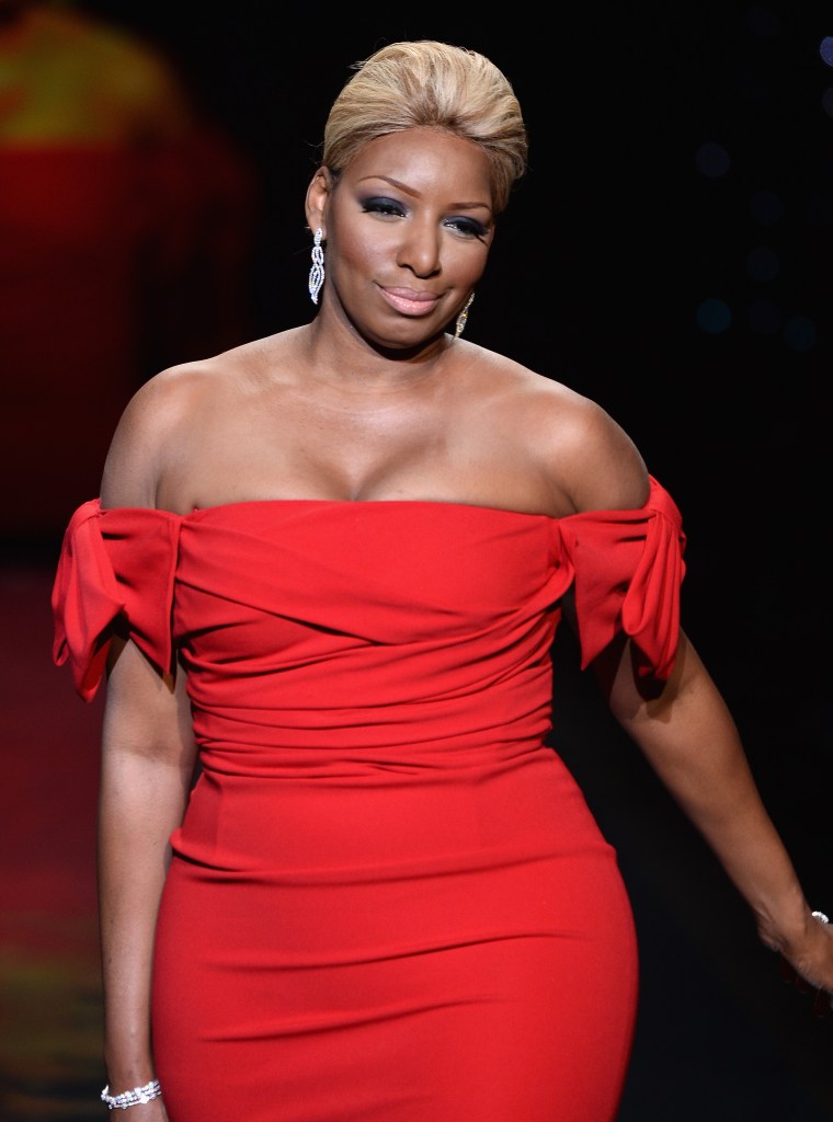 NeNe shows off her curves in red on the runway in 2014