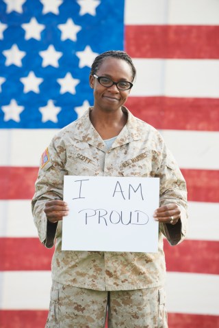 Black soldier holding empowering sign