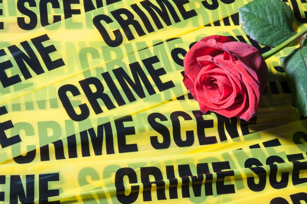 Crime scene tape and a red rose