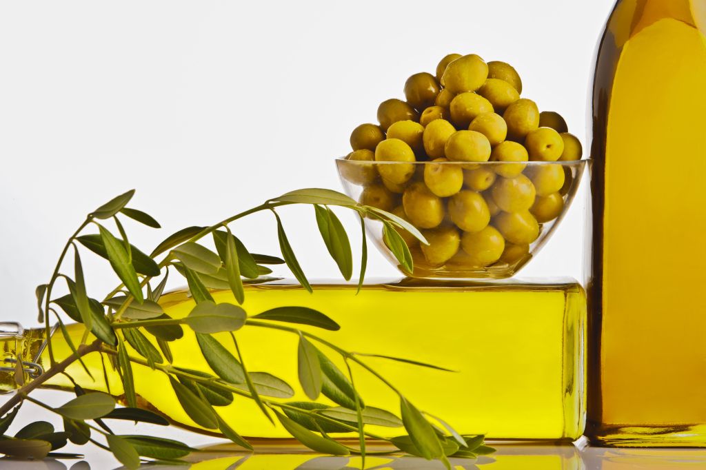 Olive oil bottles with olives