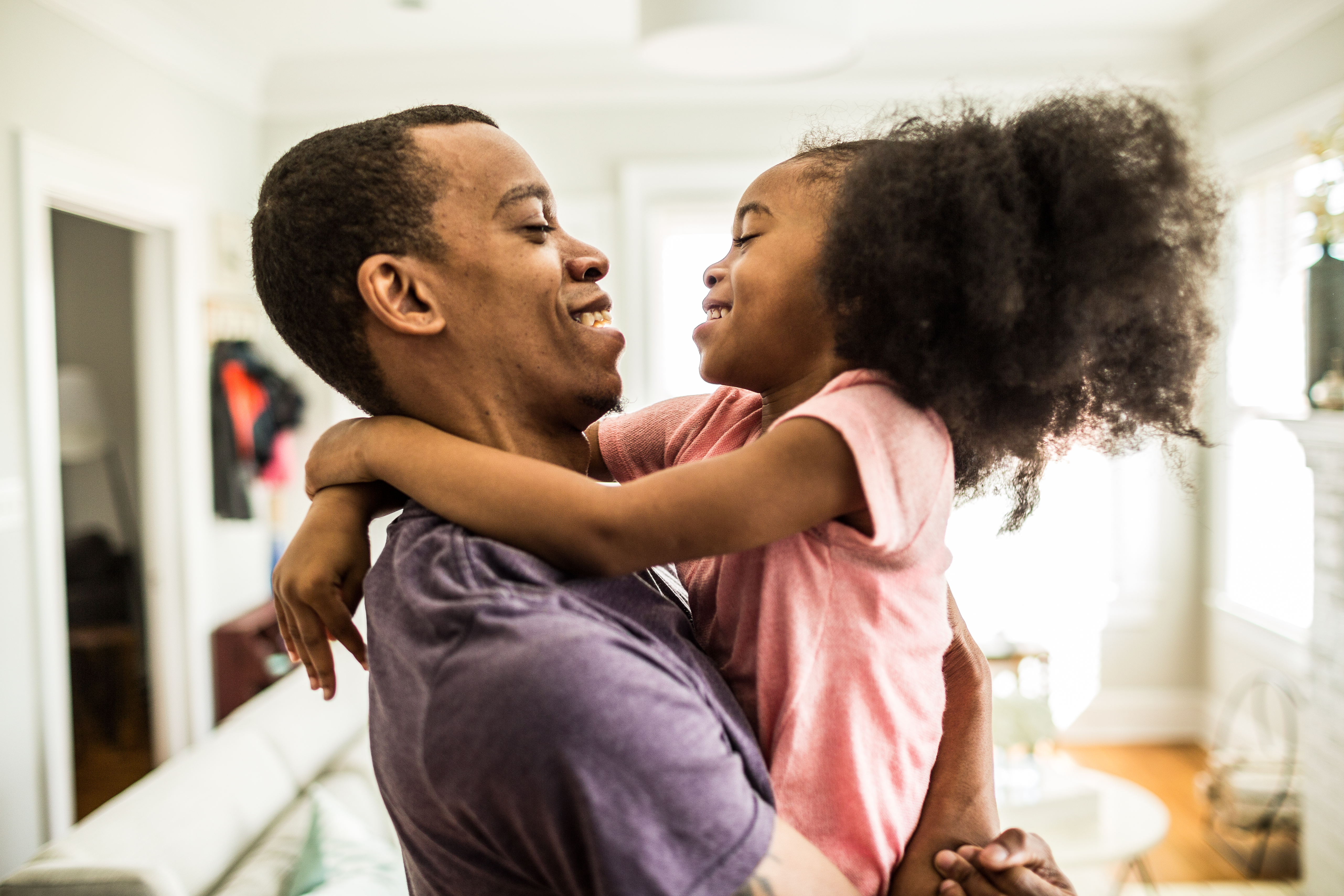 father holding daughter