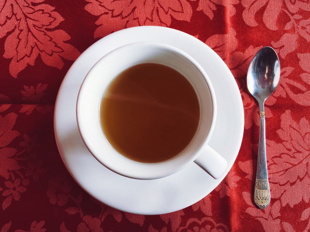 Directly Above Shot Of Tea Cup On Tablecloth