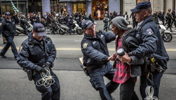 Policemen arrest a protester at the Anti-Trump rally.