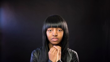 Beautiful young black woman on a black background
