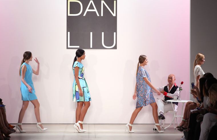 HE HANDED ROSES TO EACH MODEL AT THE END OF THE SHOW