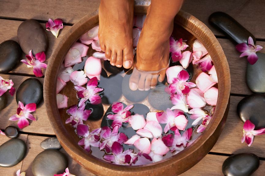 Close up of feet of Black woman soaking in bath